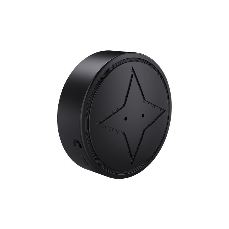 Black circular object with a star design on a white background